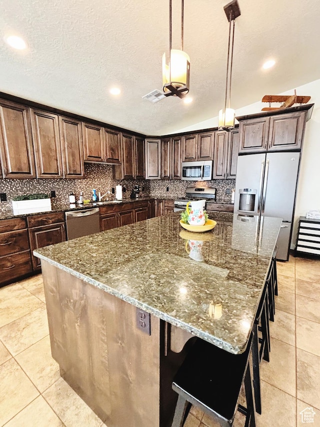 3853 Mitchell Dr, Santa Clara, UT 84765 - kitchen featuring stainless steel appliances, tasteful backsplash, dark stone countertops, a spacious island, and recessed lighting