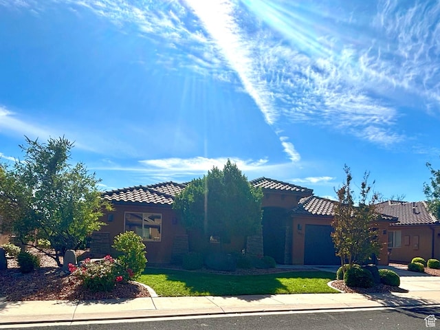 3853 Mitchell Dr, Santa Clara, UT 84765 - mediterranean / spanish home with a tile roof, concrete driveway, a garage, stucco siding, and a front yard