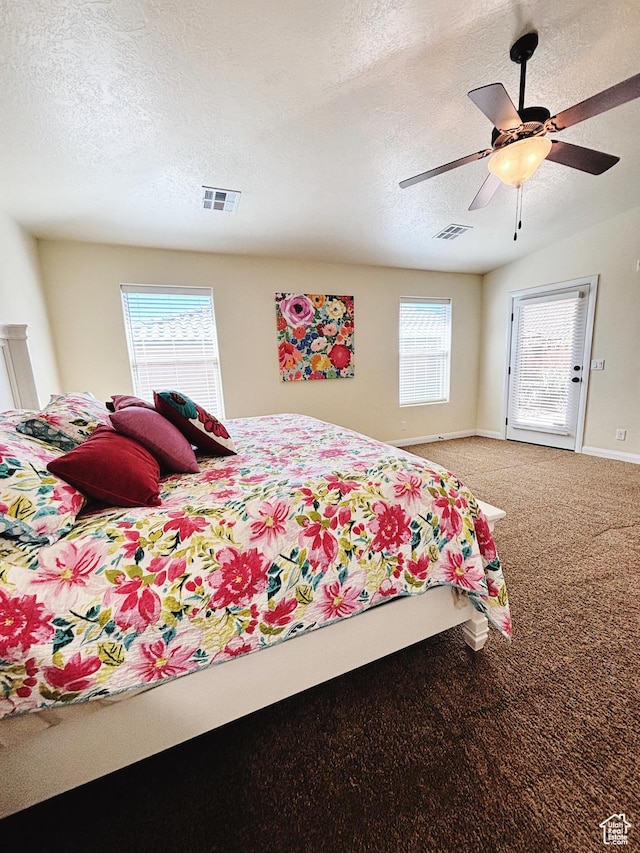 3853 Mitchell Dr, Santa Clara, UT 84765 - carpeted bedroom featuring a textured ceiling and a ceiling fan