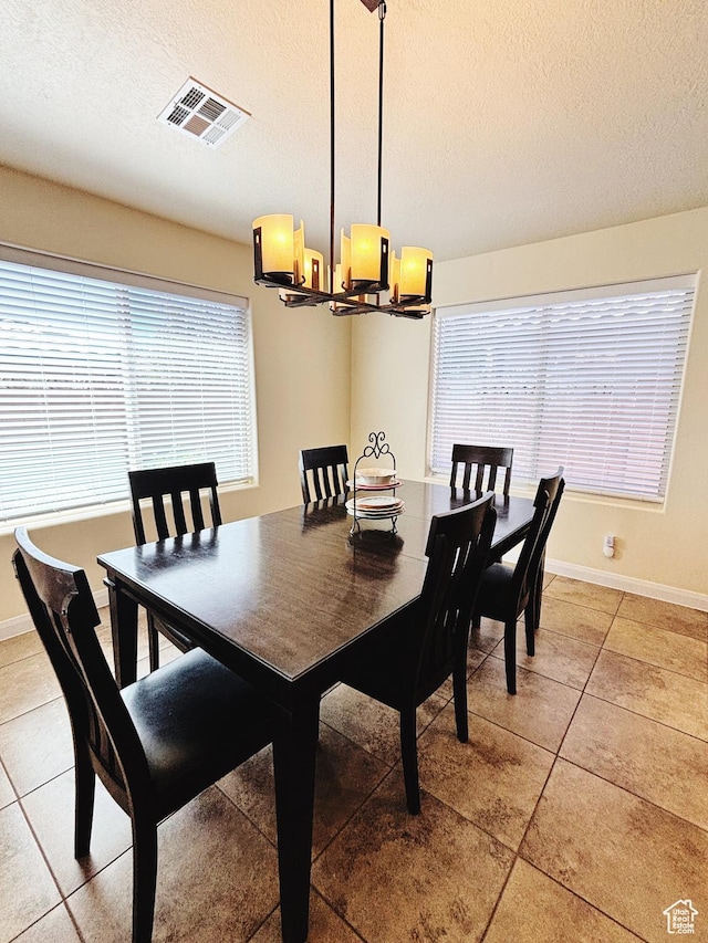 3853 Mitchell Dr, Santa Clara, UT 84765 - dining space featuring a chandelier, light tile patterned flooring, and a textured ceiling