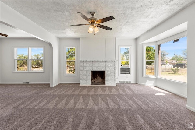 374 W Apple St, Grantsville, UT 84029 - unfurnished living room featuring a ceiling fan, carpet floors, a textured ceiling, and a fireplace
