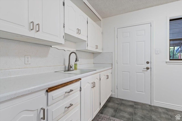 1349 W Goodwin Ave N, Salt Lake City, UT 84116 - kitchen featuring white cabinets, light countertops, a textured ceiling, and dark tile patterned floors