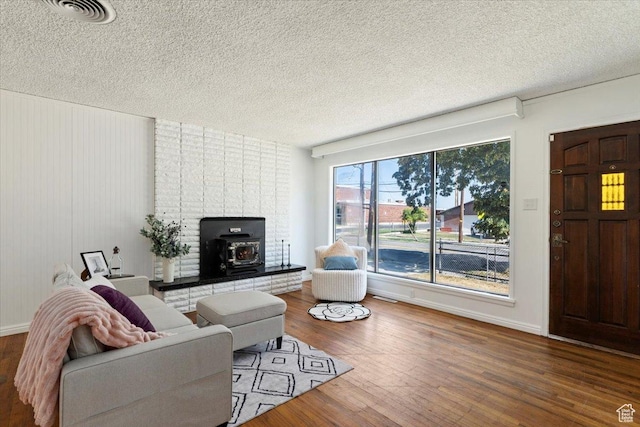 1349 W Goodwin Ave N, Salt Lake City, UT 84116 - living room featuring a wood stove, a textured ceiling, and wood finished floors