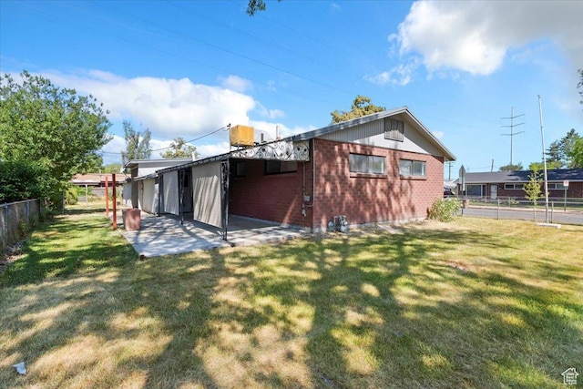 1349 W Goodwin Ave N, Salt Lake City, UT 84116 - back of property featuring a fenced backyard, brick siding, and a patio area