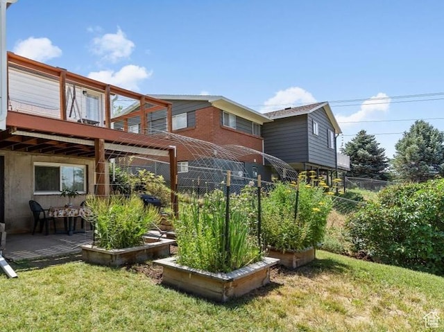 2077 Fillmore Ave, Ogden, UT 84401 - view of yard featuring a wooden deck and a garden