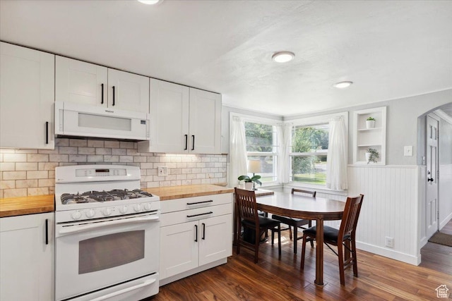 2077 Fillmore Ave, Ogden, UT 84401 - kitchen featuring white appliances, wooden counters, arched walkways, white cabinets, and dark wood-style floors