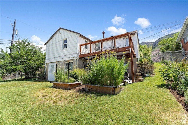 2077 Fillmore Ave, Ogden, UT 84401 - back of property featuring a yard and a wooden deck
