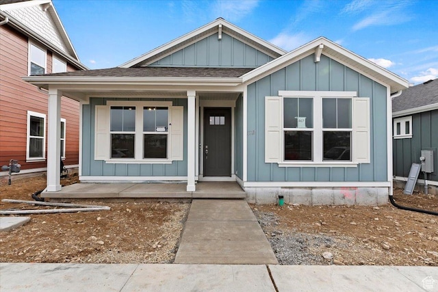 6168 W Franciscotti Dr Unit 605, South Jordan, UT 84009 - view of front of home featuring board and batten siding, covered porch, and roof with shingles
