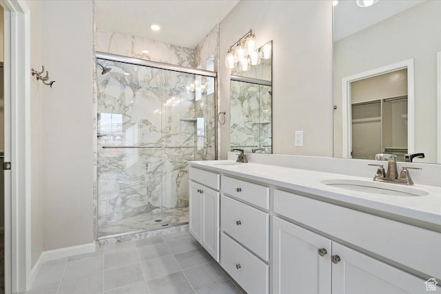 6168 W Franciscotti Dr Unit 605, South Jordan, UT 84009 - bathroom featuring a marble finish shower, a walk in closet, double vanity, and tile patterned floors