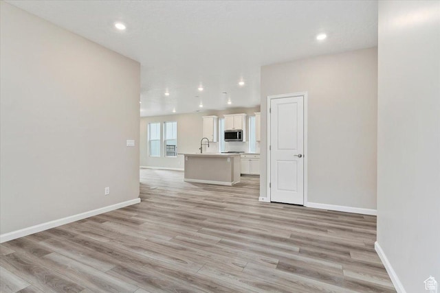 6168 W Franciscotti Dr Unit 605, South Jordan, UT 84009 - unfurnished living room featuring light wood finished floors and recessed lighting