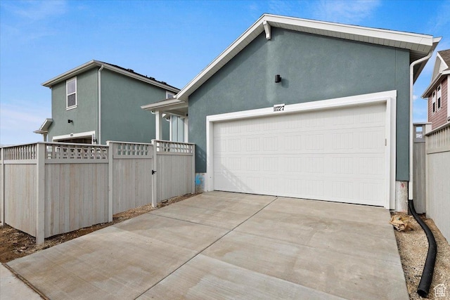 6168 W Franciscotti Dr Unit 605, South Jordan, UT 84009 - view of side of property with stucco siding, driveway, and an attached garage