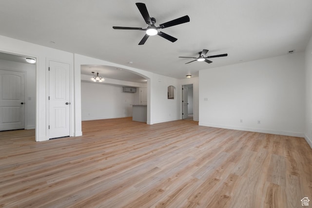 3812 E Rock Creek Rd Unit 5, Eagle Mountain, UT 84005 - unfurnished living room with ceiling fan, light wood-type flooring, arched walkways, a chandelier, and an AC wall unit