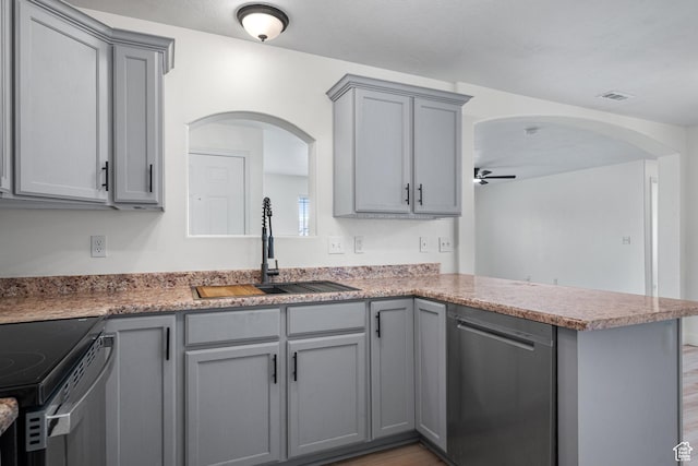3812 E Rock Creek Rd Unit 5, Eagle Mountain, UT 84005 - kitchen featuring stainless steel appliances, gray cabinetry, arched walkways, and a peninsula