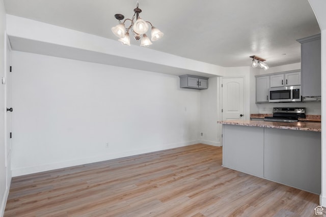 3812 E Rock Creek Rd Unit 5, Eagle Mountain, UT 84005 - kitchen with stainless steel appliances, gray cabinetry, light wood-style flooring, a chandelier, and stone countertops