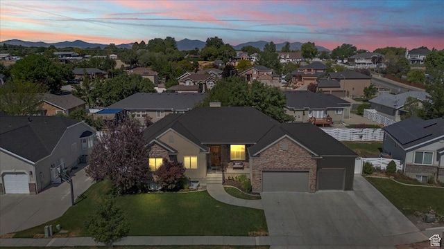 6264 S Dellron Dr, Murray, UT 84123 - view of front of property with concrete driveway, a residential view, stone siding, a mountain view, and a garage