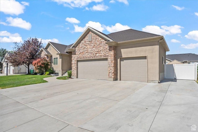 6264 S Dellron Dr, Murray, UT 84123 - view of front of house with concrete driveway, a garage, stone siding, and stucco siding