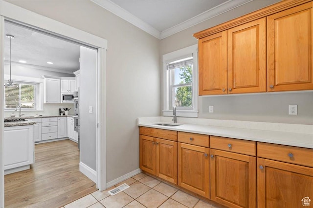 6264 S Dellron Dr, Murray, UT 84123 - kitchen with stainless steel appliances, crown molding, light countertops, recessed lighting, and brown cabinetry