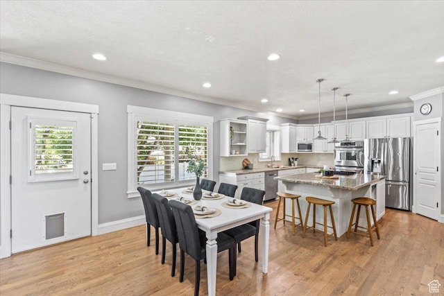 6264 S Dellron Dr, Murray, UT 84123 - dining area with crown molding, plenty of natural light, recessed lighting, and light wood finished floors