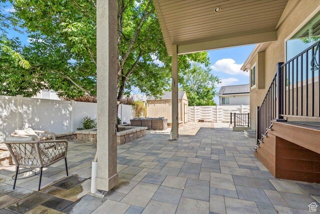 6264 S Dellron Dr, Murray, UT 84123 - fenced backyard with a patio, outdoor lounge area, and a storage shed