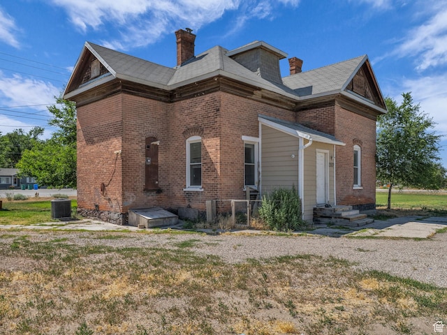 13225 S Redwood Rd, Riverton, UT 84065 - view of side of home featuring a chimney and brick siding