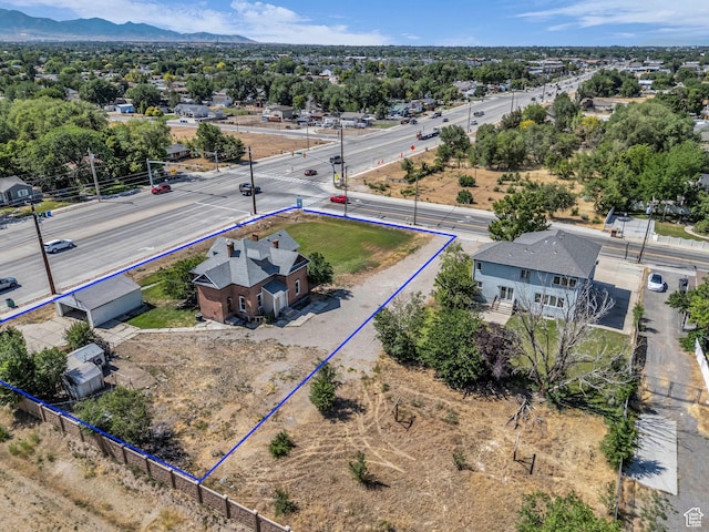 13225 S Redwood Rd, Riverton, UT 84065 - aerial view of property and surrounding area with property parcel outlined and a mountain backdrop