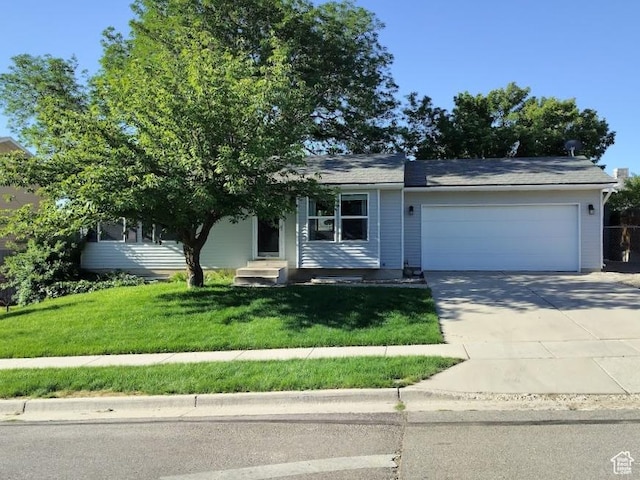 5373 W 6600 S, West Jordan, UT 84081 - view of front of property with an attached garage, driveway, a front yard, and entry steps