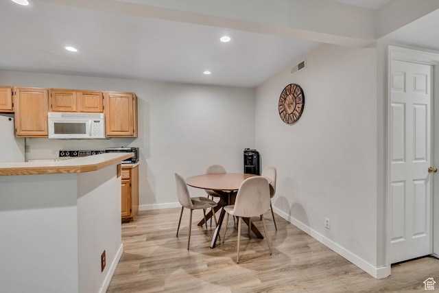 650 S Main St Unit 8102, Bountiful, UT 84010 - kitchen featuring white microwave, refrigerator, recessed lighting, light countertops, and light wood finished floors