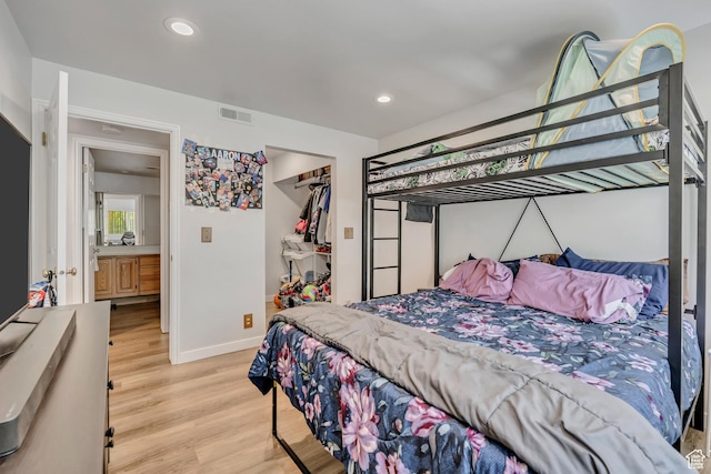 650 S Main St Unit 8102, Bountiful, UT 84010 - bedroom featuring light wood-type flooring, recessed lighting, a closet, and a walk in closet