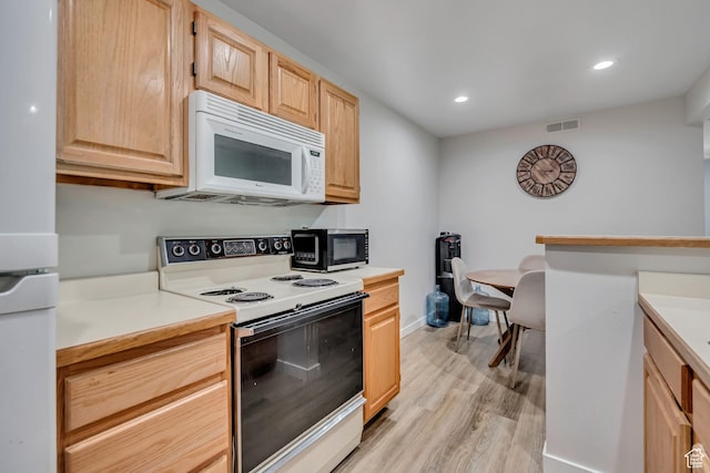 650 S Main St Unit 8102, Bountiful, UT 84010 - kitchen featuring white appliances, light brown cabinetry, light wood-style flooring, light countertops, and recessed lighting