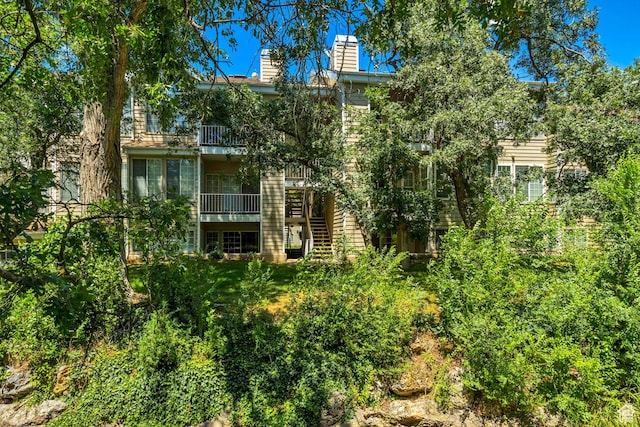 650 S Main St Unit 8102, Bountiful, UT 84010 - back of property with a chimney, stairs, and a balcony