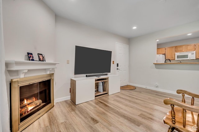 650 S Main St Unit 8102, Bountiful, UT 84010 - living room with a glass covered fireplace, recessed lighting, and light wood finished floors