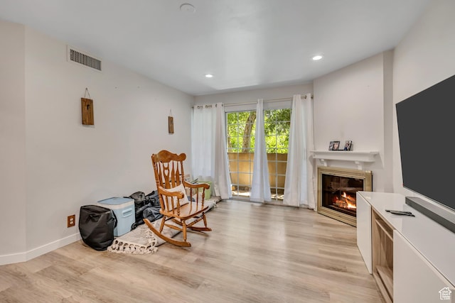650 S Main St Unit 8102, Bountiful, UT 84010 - living area featuring light wood-type flooring, a glass covered fireplace, and recessed lighting