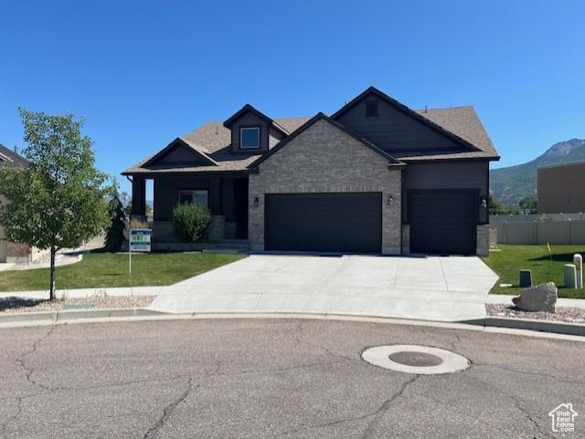 649 E 5650 S, Washington Terrace, UT 84405 - view of front of house with a garage, driveway, and stone siding