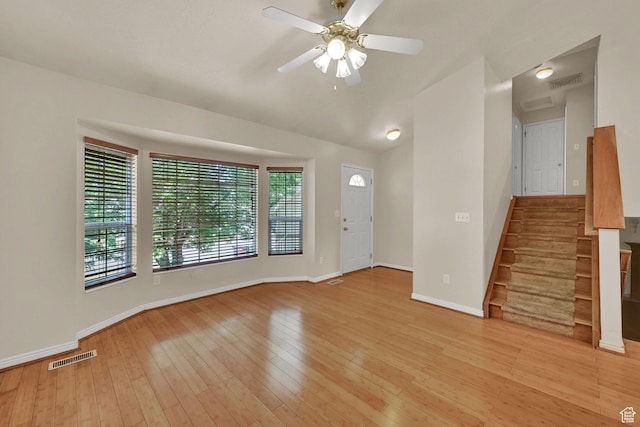 4188 S 2725 W, Roy, UT 84067 - unfurnished living room featuring light wood-type flooring, a ceiling fan, stairway, and vaulted ceiling
