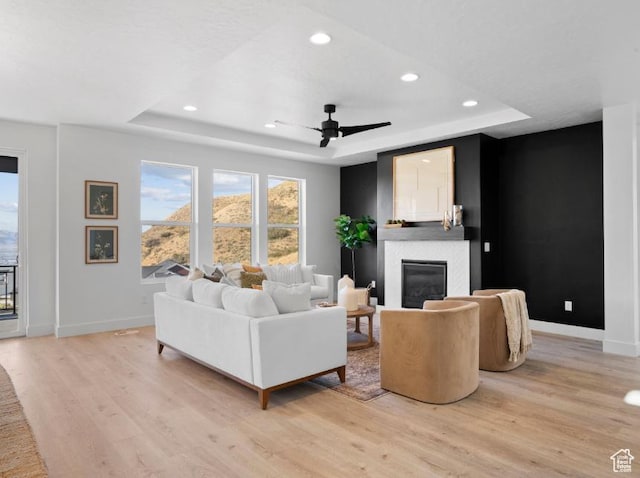 5885 N Canyon Rim Rd Unit 624, Lehi, UT 84043 - living room with a raised ceiling, light wood-style floors, a glass covered fireplace, and recessed lighting