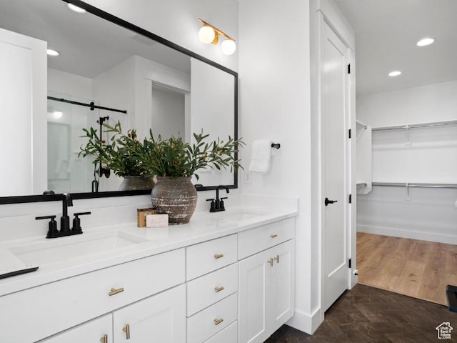 5885 N Canyon Rim Rd Unit 624, Lehi, UT 84043 - bathroom featuring double vanity, a spacious closet, a shower stall, and recessed lighting