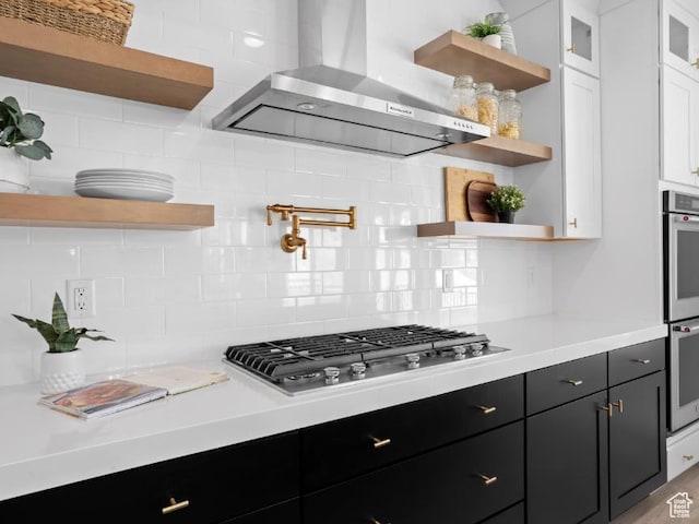 5885 N Canyon Rim Rd Unit 624, Lehi, UT 84043 - kitchen with open shelves, wall chimney range hood, stainless steel gas stovetop, white cabinetry, and dark cabinets