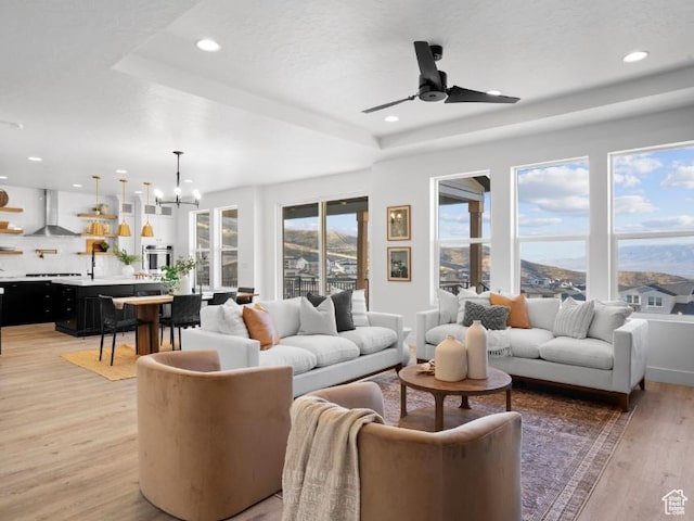 5885 N Canyon Rim Rd Unit 624, Lehi, UT 84043 - living area featuring a raised ceiling, light wood-type flooring, a chandelier, a ceiling fan, and recessed lighting