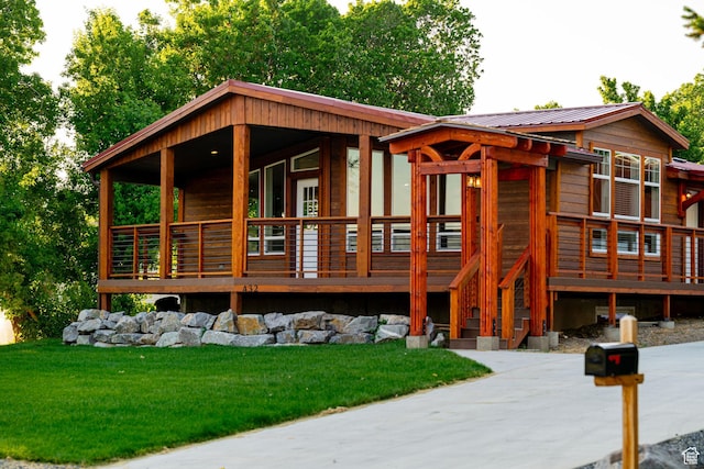 432 E 2700 N, North Ogden, UT 84414 - log-style house with a metal roof, a front lawn, and a deck
