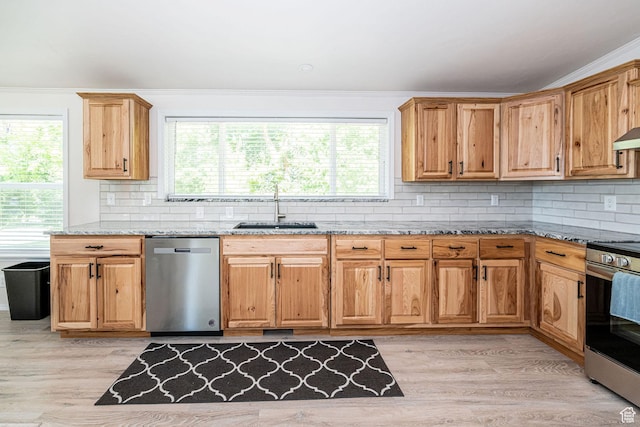 432 E 2700 N, North Ogden, UT 84414 - kitchen featuring appliances with stainless steel finishes, light stone countertops, light wood finished floors, plenty of natural light, and crown molding