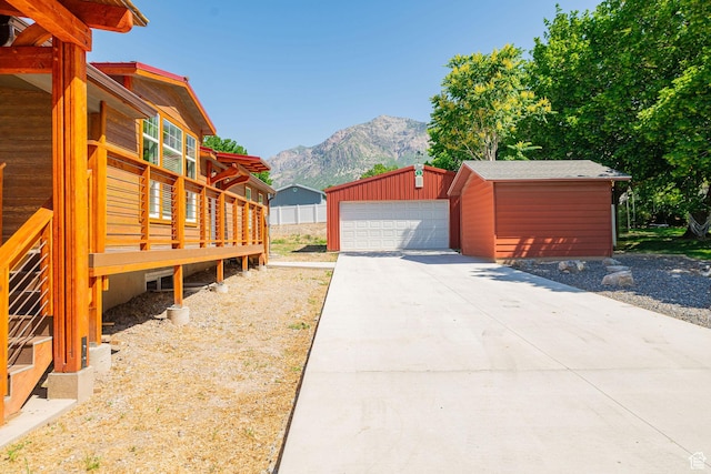 432 E 2700 N, North Ogden, UT 84414 - view of home's exterior with an outdoor structure, a detached garage, and a deck with mountain view