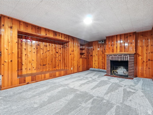 1951 W 4900 S, Roy, UT 84067 - unfurnished living room featuring carpet, wooden walls, and a fireplace