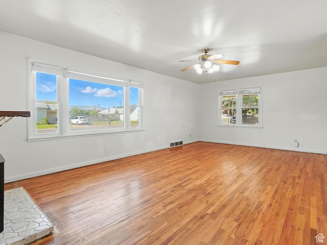 1951 W 4900 S, Roy, UT 84067 - unfurnished living room with light wood-style floors and ceiling fan