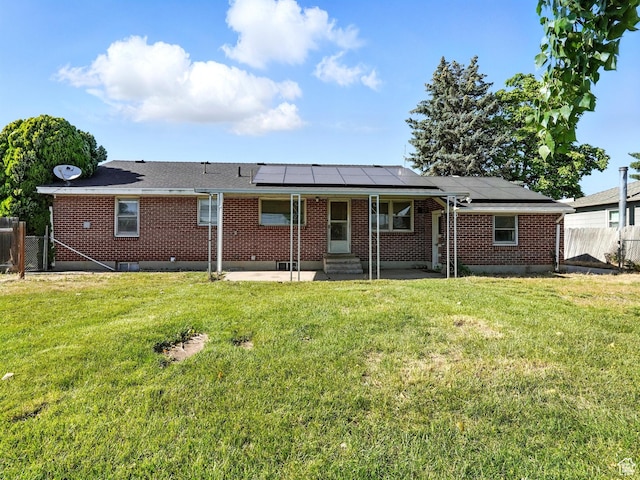 1951 W 4900 S, Roy, UT 84067 - rear view of property featuring entry steps, a patio, a fenced backyard, and roof mounted solar panels