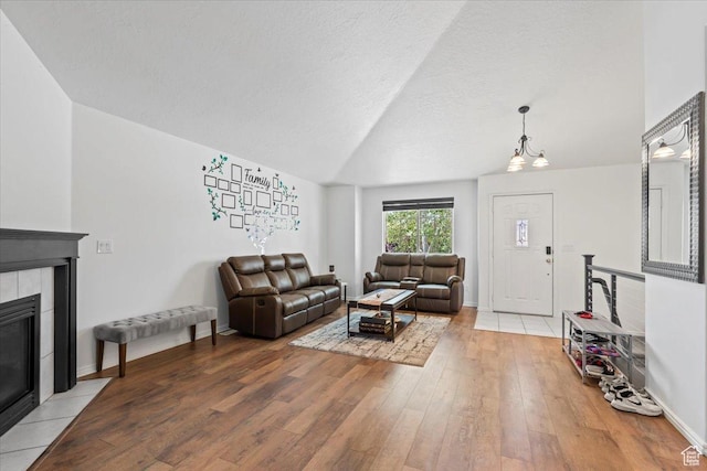 3186 N 1175 E, Layton, UT 84040 - living room with a fireplace, lofted ceiling, and light wood-style flooring