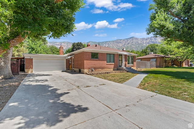 680 E 2800 N, North Ogden, UT 84414 - ranch-style house featuring a chimney, a mountain view, brick siding, an attached garage, and driveway