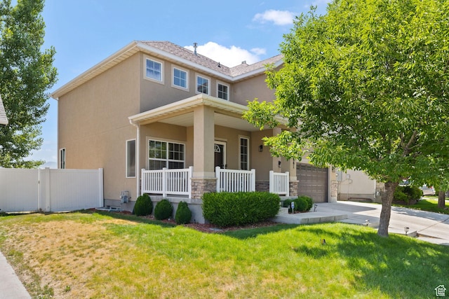 3991 W Hollandia Ln, West Jordan, UT 84084 - view of front of property with a porch, stucco siding, stone siding, driveway, and a garage