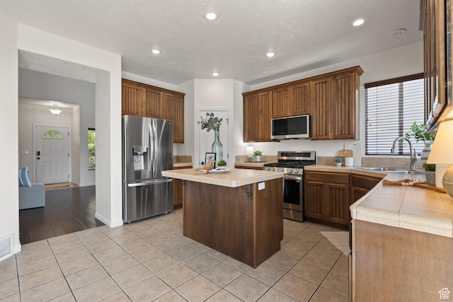 3991 W Hollandia Ln, West Jordan, UT 84084 - kitchen featuring stainless steel appliances, light countertops, a kitchen island, plenty of natural light, and recessed lighting