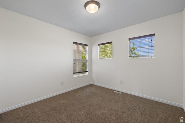 3991 W Hollandia Ln, West Jordan, UT 84084 - empty room featuring baseboards and dark colored carpet