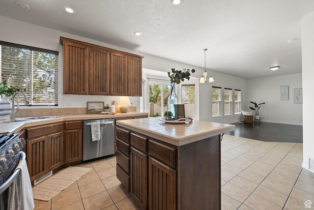 3991 W Hollandia Ln, West Jordan, UT 84084 - kitchen featuring stainless steel appliances, tile countertops, light tile patterned flooring, plenty of natural light, and recessed lighting
